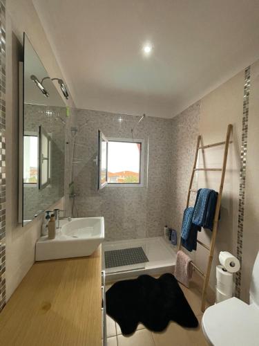 a bathroom with a sink and a bath tub at VILLA Valhalla Private heated swimming-pool in Funchal