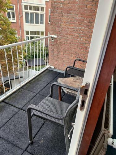 two chairs sitting on the balcony of a building at New City Hotel Scheveningen in Scheveningen