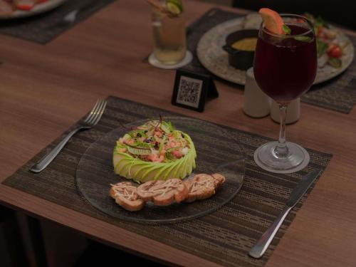 a plate of food on a table with a drink at ibis Lima Reducto Miraflores in Lima