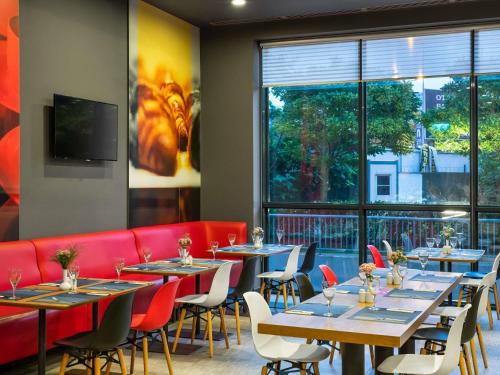 a restaurant with tables and chairs and a large window at Ibis Istanbul Tuzla Hotel in Tuzla