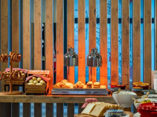 a table with bread and other food on it at Ibis Istanbul Tuzla Hotel in Tuzla
