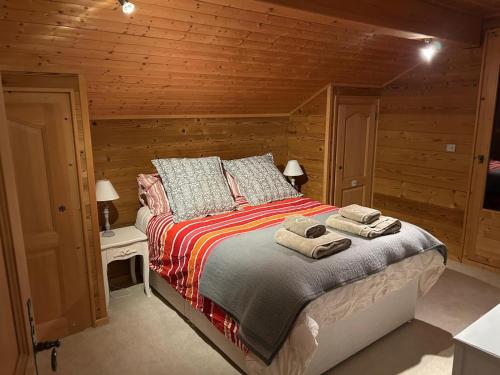 una camera da letto con un letto con due asciugamani sopra di Kandahar - 4 bed chalet close to pistes, Morillon a Morillon