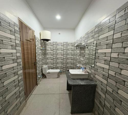 a bathroom with a sink and a toilet at Radiant Blu Hotel in Noida