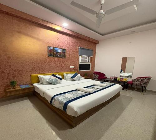 a bedroom with a large bed in a room at Radiant Blu Hotel in Noida