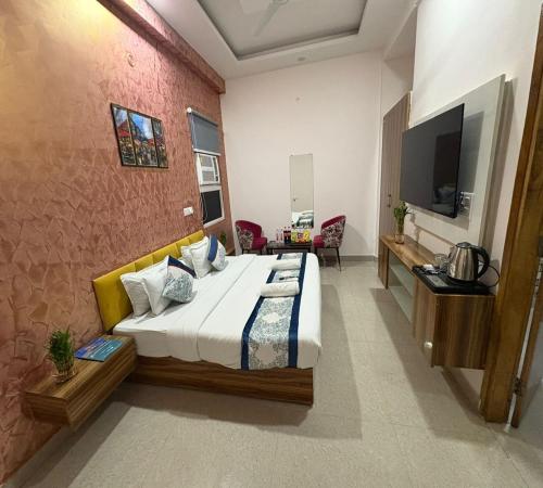 a hotel room with a bed and a television at Radiant Blu Hotel in Noida