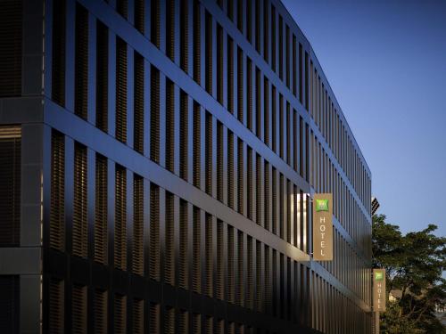 a black building with a sign on the side of it at ibis Styles Basel City in Basel