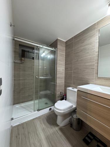 a bathroom with a shower and a toilet and a sink at Arriendo dos dormitorios Costas in Concón