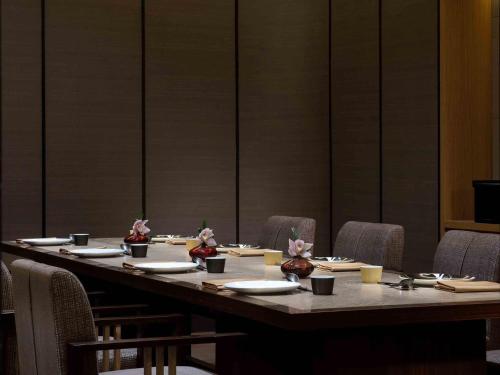 a long table in a room with chairs at Sofitel Shanghai Hongqiao in Shanghai