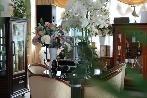 a camera sitting on top of a table with flowers at Apart-hotel Integra in Banja Luka