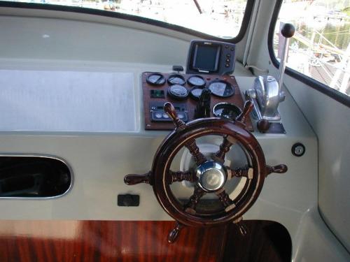 an interior of a boat with a steering wheel at Albin 25 Graddoe Harbour in Gräddö