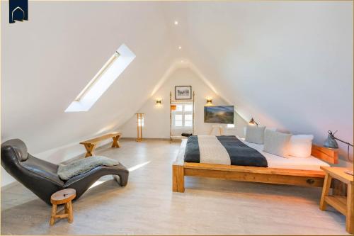 a bedroom with a large bed and a chair at Alte Post Liepe in Rankwitz