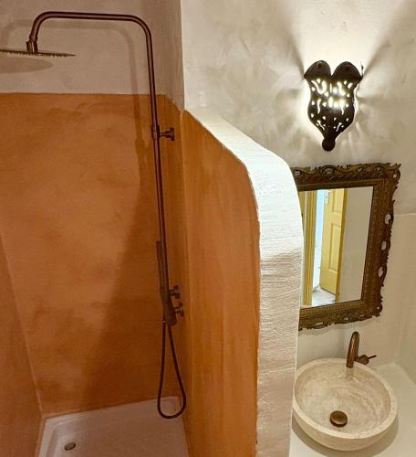 a bathroom with a shower with a sink and a mirror at La cigale bleue - Garden level in Sanary-sur-Mer