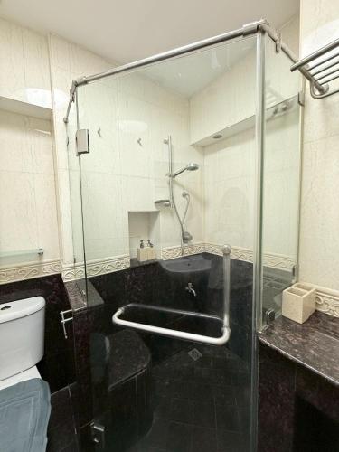 a bathroom with a glass shower and a toilet at Hillside Condo 2 in Chiang Mai