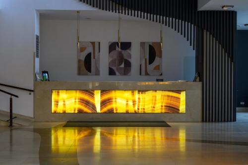 a fireplace in a room with yellow flames at Grand Hotel Napoca in Cluj-Napoca