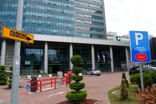 a parking sign in front of a large building at Apart-hotel Integra in Banja Luka