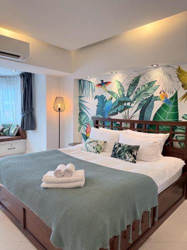 a bedroom with a large bed with two towels on it at Hillside Condo 2 in Chiang Mai