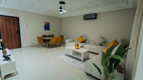 a living room with a couch and a table at Appart Hôtel Golden Sky Home Café Restaurant & Spa in Beni Mellal