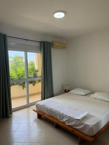 Ένα ή περισσότερα κρεβάτια σε δωμάτιο στο Mira Mar Condominium, Palmarejo Baixo