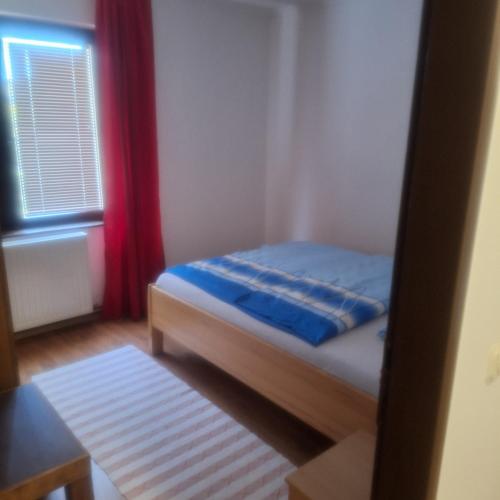 a small bedroom with a bed and a window at Apartman Kenedi3 in Kiseljak