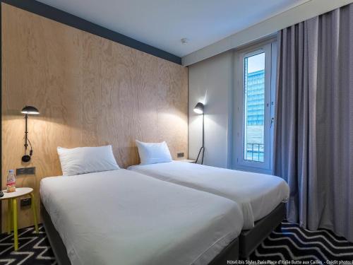 a hotel room with a large bed and a window at Ibis Styles Paris Place d'Italie - Butte Aux Cailles in Paris