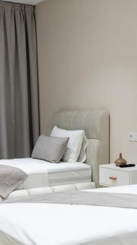 two beds sitting next to each other in a room at Appart Hôtel Golden Sky Home Café Restaurant & Spa in Beni Mellal