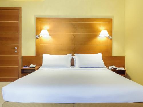 a large white bed with two pillows in a room at Ibis Styles Bari Giovinazzo in Giovinazzo