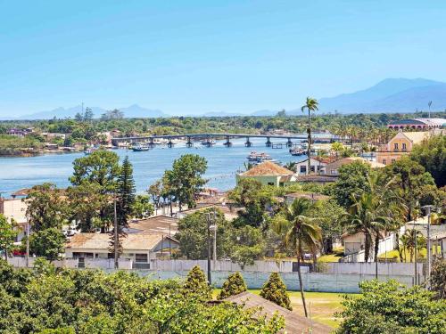 a view of a town with a bridge over a river at ibis Paranagua in Paranaguá
