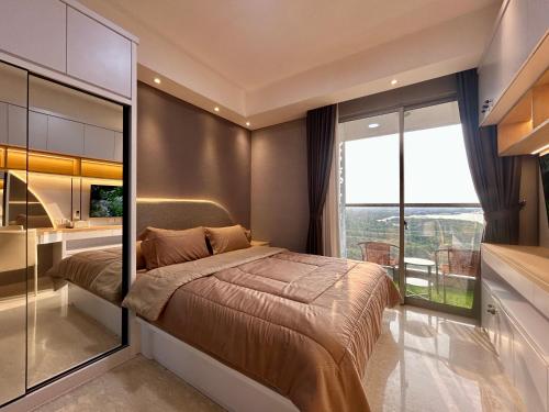 a bedroom with a large bed and a large window at Gold Coast Apartment PIK Luxury Sea View by stay with E in Jakarta