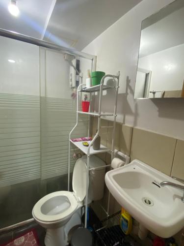a bathroom with a toilet and a sink at Jb Place Hernan in Cebu City