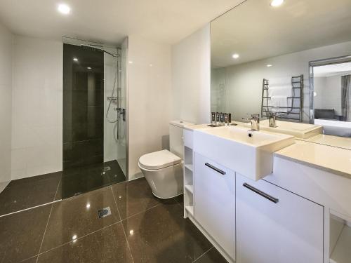 a bathroom with a sink and a toilet and a shower at Novotel Surfers Paradise in Gold Coast