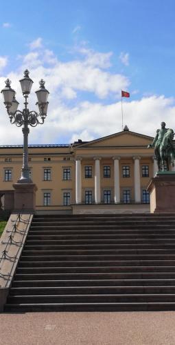 a building with stairs in front of a building with a flag at First Hotel Millennium in Oslo