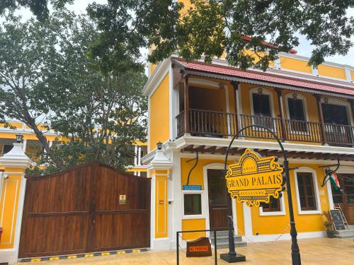 a yellow building with a sign that reads grand palmas at Hotel Grand Palais in Bengaluru