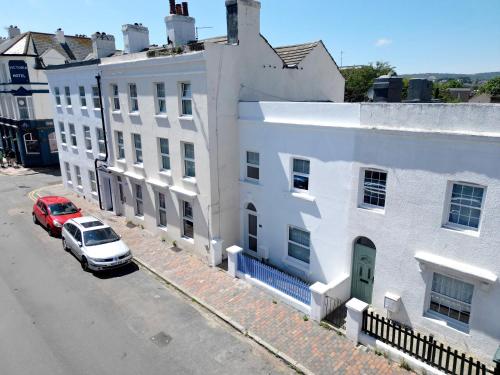 an aerial view of a white building with a red car at Beach House in Eastbourne
