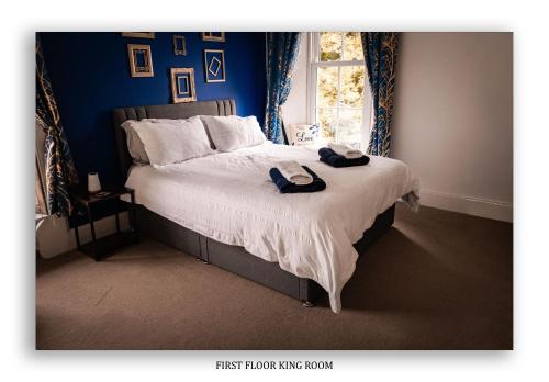 a bedroom with a bed with two towels on it at Clarefoot Cottage in Moffat