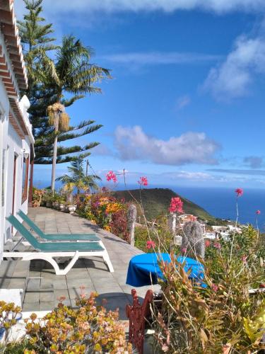 a patio with a chair and a view of the ocean at Casa Rural Los Estrello in Puntallana