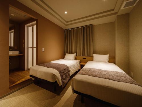 Postel nebo postele na pokoji v ubytování Hotel Espasion Pontocho