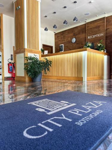 a lobby with a waiting area with a blue carpet at City Plaza in Botevgrad