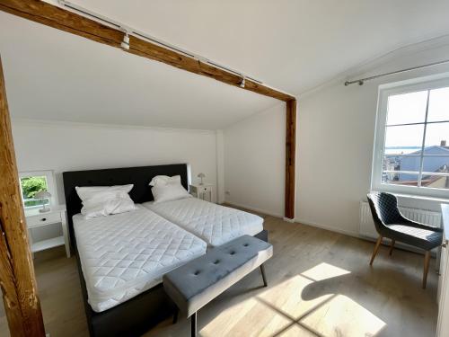 a bedroom with a white bed and a window at Fewo-meerblick-Rügen in Altefähr