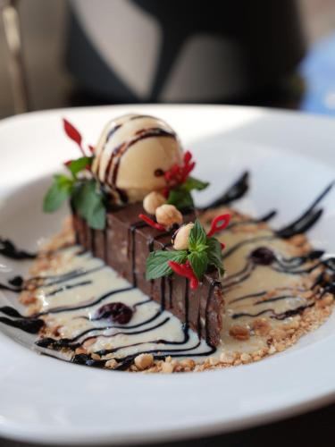 a dessert on a white plate with an ice cream cake at Apart-hotel Integra in Banja Luka