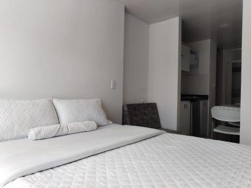 Postel nebo postele na pokoji v ubytování Apartahotel Barú - Usaquén