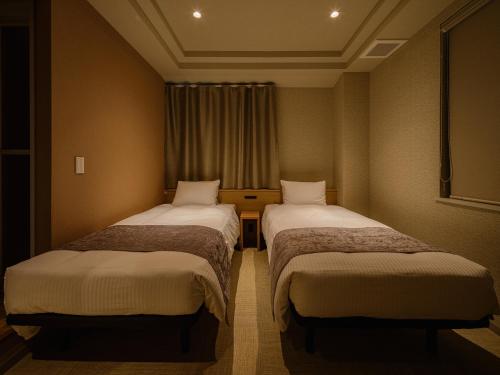 Postel nebo postele na pokoji v ubytování Hotel Espasion Pontocho