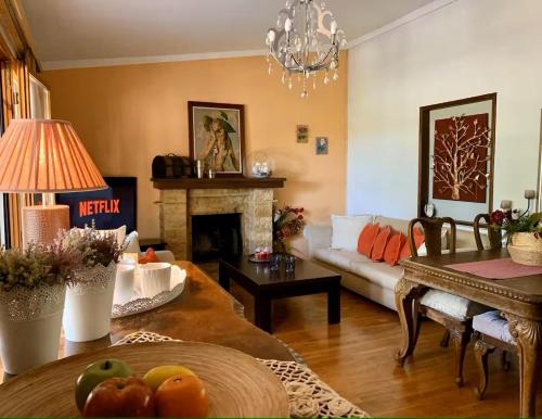 a living room with a couch and a table at Daydream Nature Home - Hot Tub & Cinema Experience in Oinóï