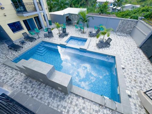 an overhead view of a swimming pool with chairs at La Source, Kribi in Kribi