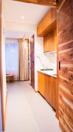 uma cozinha com armários de madeira e um fogão em House B thonningii - warm minimalism em Nanyuki