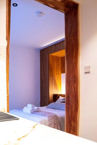a mirror in a bedroom with two beds at House B thonningii - warm minimalism in Nanyuki