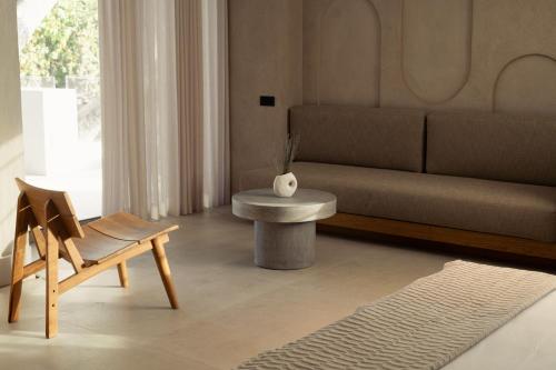a living room with a couch and a table at Beau Rivage Suites in Lóngos