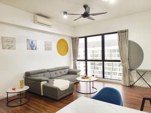 a living room with a couch and a ceiling fan at SQ31 Sq where 55 inch 4 ktv sungai buloh in Shah Alam