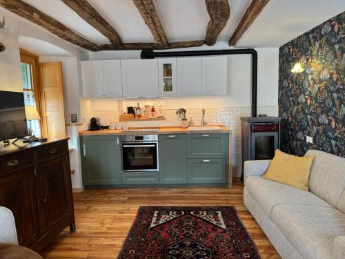 a living room with a couch and a kitchen at La Ceresina in Ceres