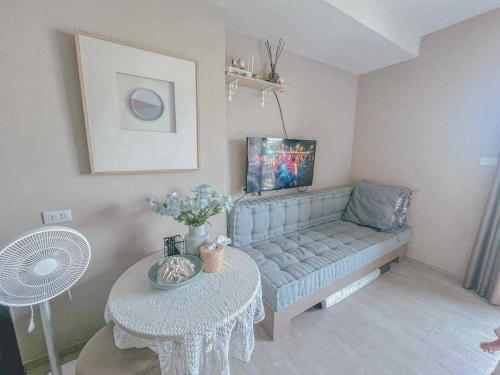 a living room with a couch and a table at Exclusive Apartment with Pool - Self Check In in Hua Hin