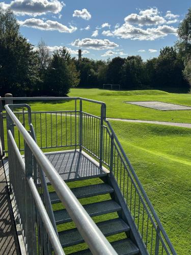 a set of stairs leading to a golf course at Pulzion - Sportshotel in Kolding